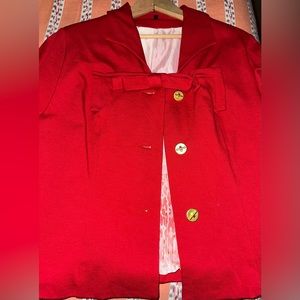 Red blazer with bow and gold accents